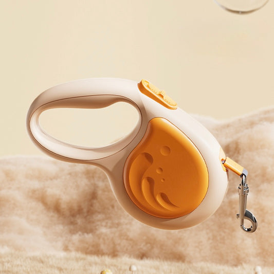 Retractable dog leash with orange and white design on a beige background